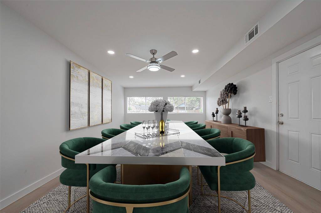 *virtually staged* This dining room is also brightened by recessed lighting and a ceiling fan, creating a comfortable atmosphere for meals or gatherings.