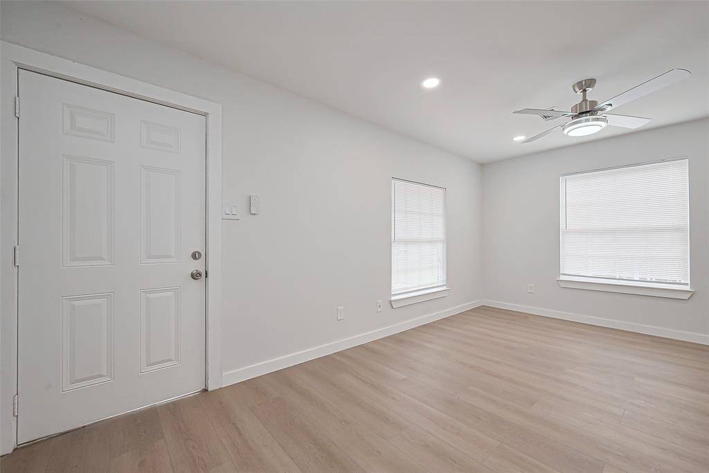 Upon entry, the living room greets you with its large windows, filling the space with natural light and creating a bright, airy atmosphere perfect for relaxation.