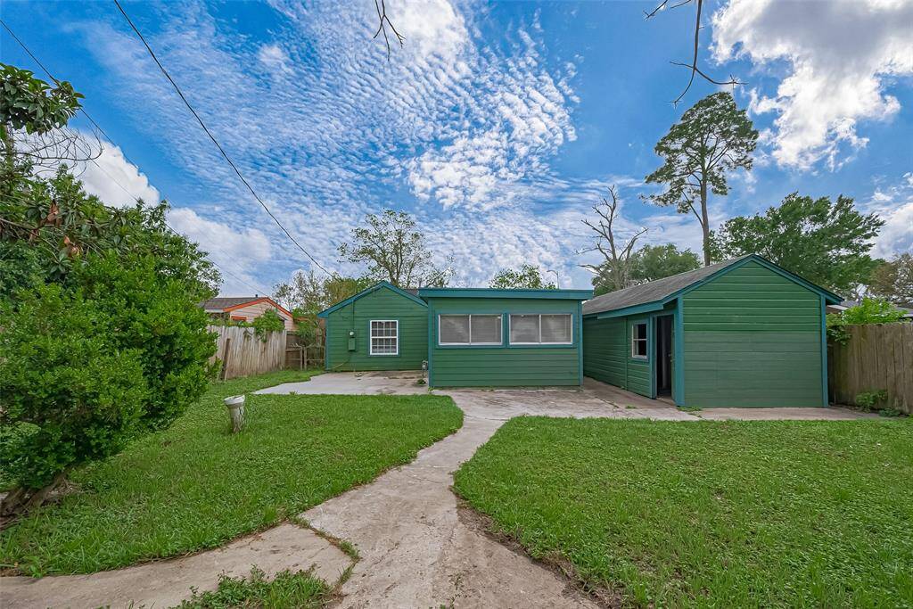 From the backyard, enjoy a picturesque view of the rear of the home, where a storage shed adds extra convenience for your outdoor gear and tools.