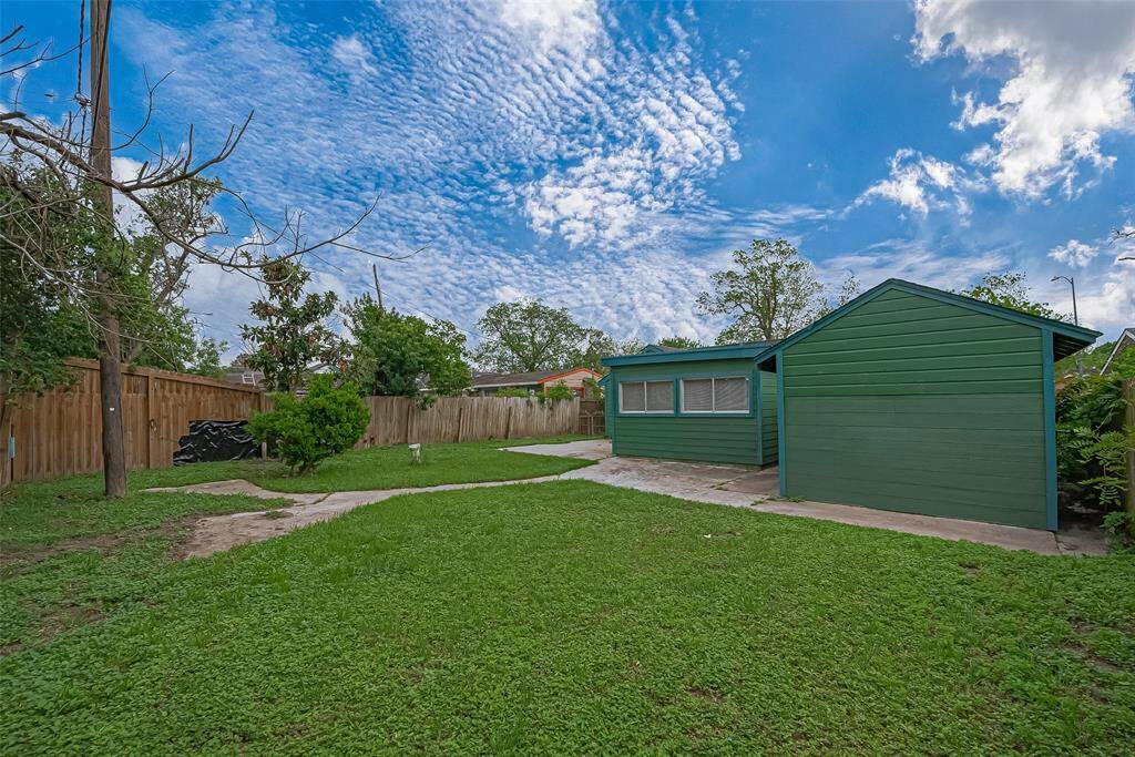 The backyard offers a blend of paved and grassy areas, making it a versatile space perfect for both gatherings and quiet moments of solitude.