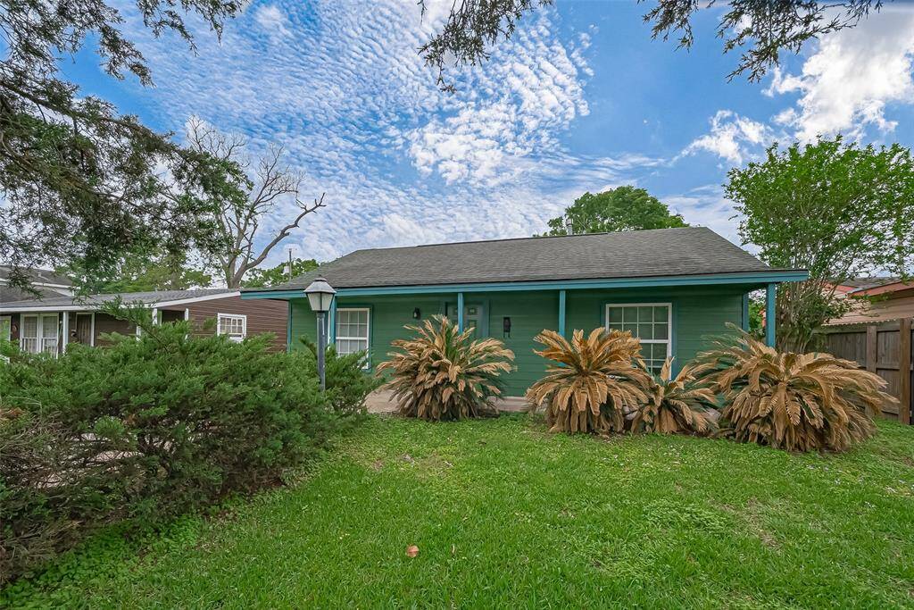 Another angle of the front showcases the well-maintained grass and plants, adding to the home’s welcoming exterior.