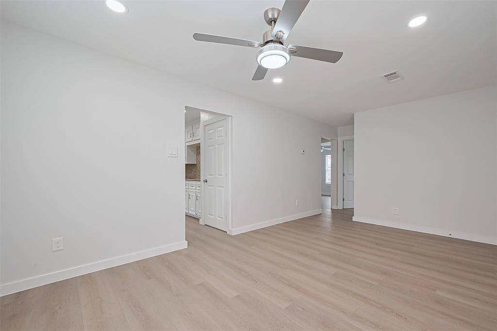 The living room offers inviting views of both the kitchen and nearby bedroom areas, making it easy to stay connected while enjoying the comfort of the space.