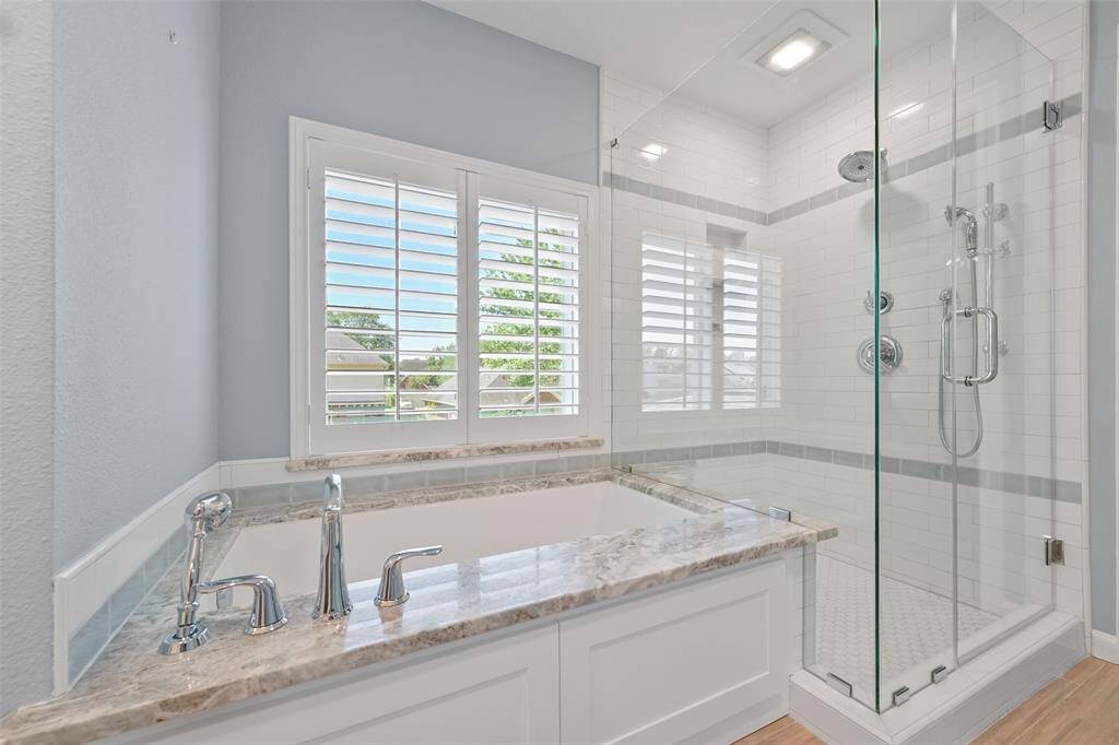 ENJOY A SPA-LIKE EXPERIENCE IN THIS FRAMELESS GLASS SHOWER AND SOAKING TUB.
