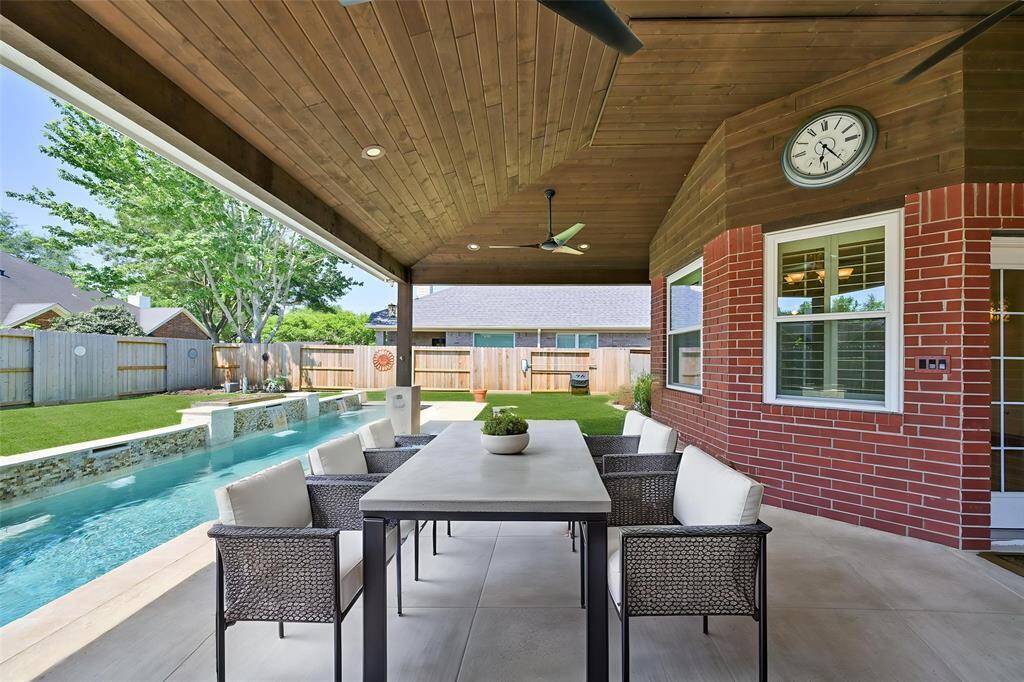 ENJOY SUMMER DAYS UNDER THE SHADE OF YOUR PATIO, GAZING OUT TO THE GLEAMING POOL AND SPA. **This room has been virtually staged.