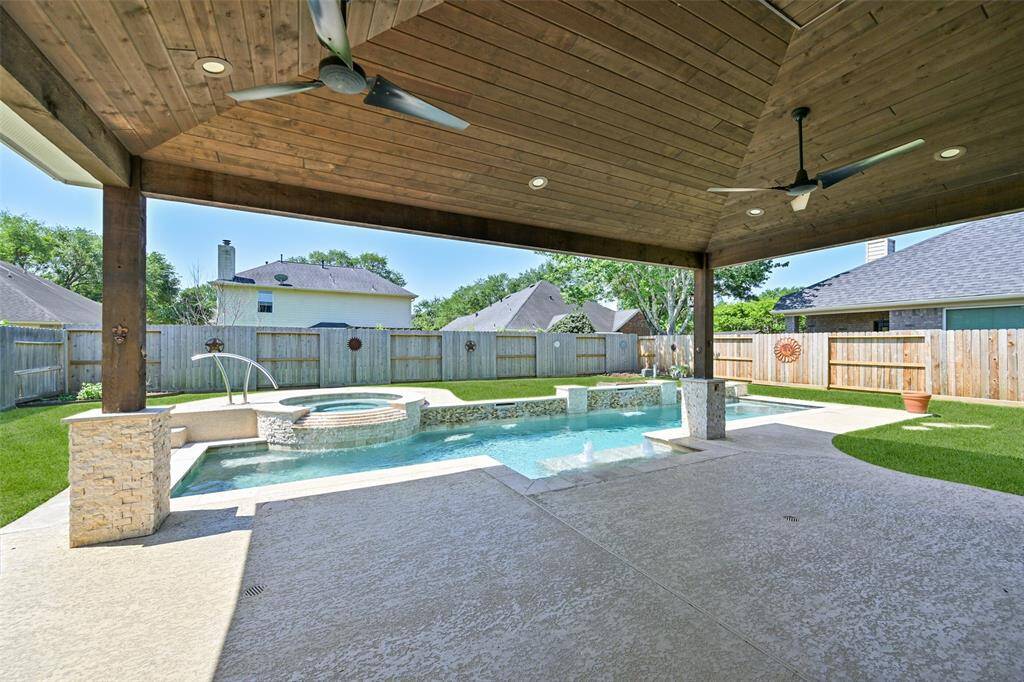 RELAX IN YOUR PRIVATE BACKYARD OASIS FEATURING A SPARKLING POOL, BUILT-IN SPA, AND WATER FEATURES FOR THE ULTIMATE RESORT VIBE.