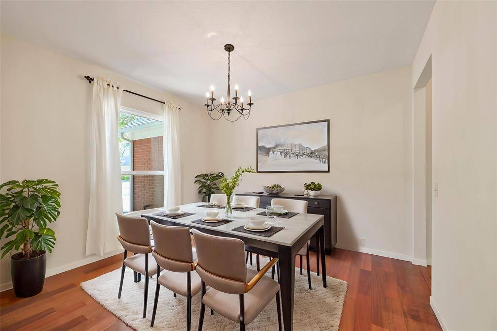 ELEGANT FORMAL DINING ROOM WITH WARM WOOD FLOORS AND A CLASSIC CHANDELIER. **This room has been virtually staged.