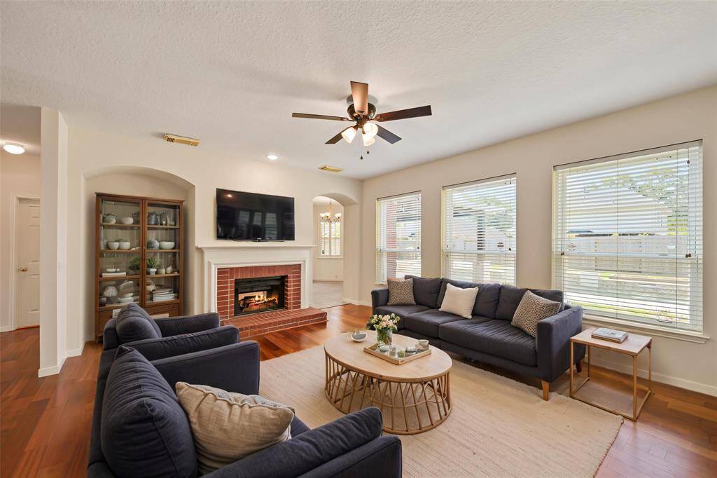 THIS INVITING FAMILY ROOM FEATURING 2025 INTERIOR NEUTRAL PAINT, BEAUTIFUL ENGINEERED WOOD FLOORS, AND ENERGY-EFFICIENT DUAL PANE WINDOWS OVERLOOKING THE BACKYARD. **This room has been virtually staged.