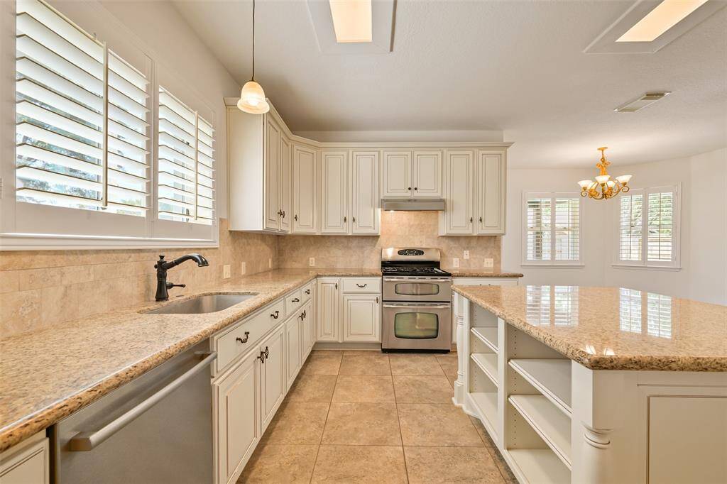 ENJOY EFFICIENCY WITH LOWER CABINET PULLOUTS, A WHOLE HOUSE WATER FILTER, AND GRANITE SURFACES.