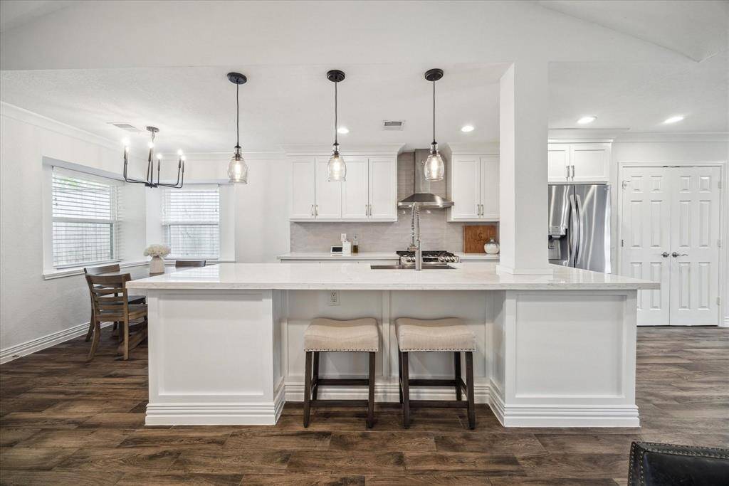 You'll love having a kitchen with soft close cabinets/drawers, ample quartz counter space, a gas range with dual ovens, pendant lighting, and a large pantry.