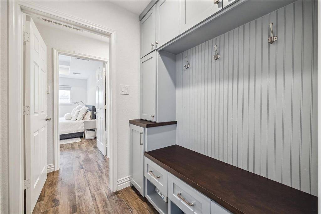 The mud room lies conveniently off the garage and offers custom built-ins with hooks and storage.