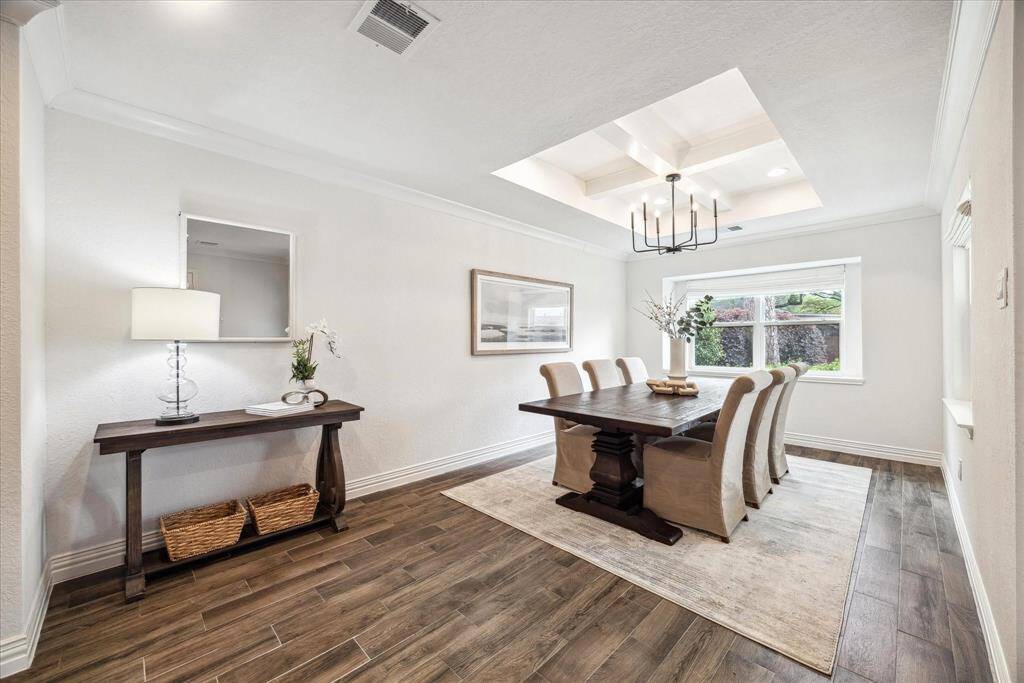 An inset ceiling adds elegance to this spacious dining room which will accommodate your largest gatherings.