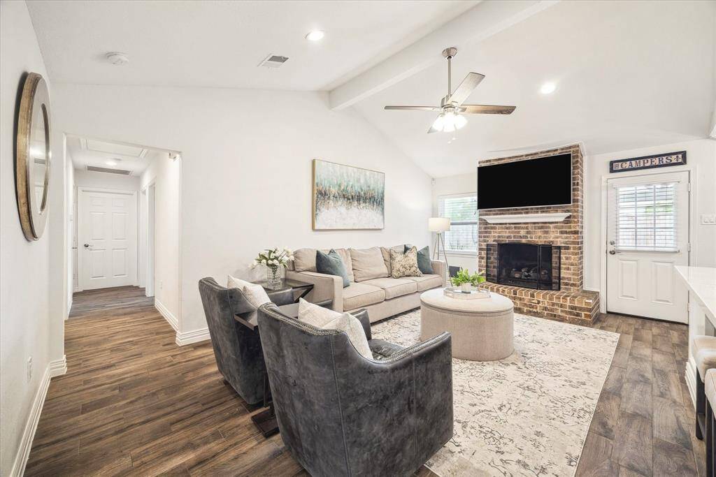 This living space is truly the heart of the home with a vaulted ceiling, recessed lighting, and a gaslog fireplace.