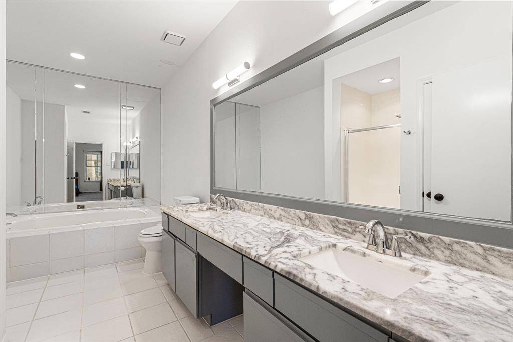 Elegant master bathroom featuring sleek granite countertops and modern updates.