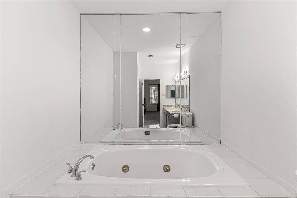Indulge in ultimate relaxation with this inviting soaking tub, perfect for unwinding with a book and beverage.