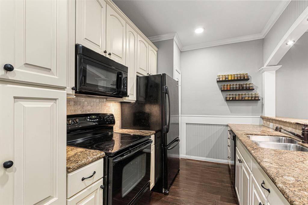 Discover the kitchen's modern charm with updated soft-close cabinets offering extra storage, a stylish accent color, and a granite bar illuminated by LED lighting with a dimmer switch.