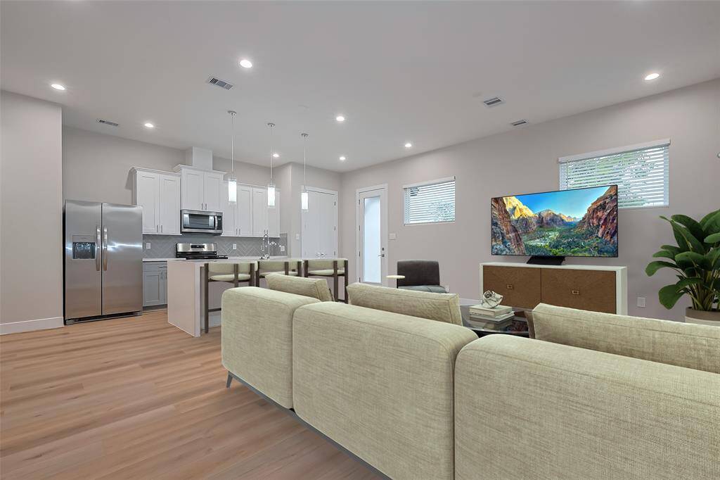 Open concept living room and kitchen virtually staged