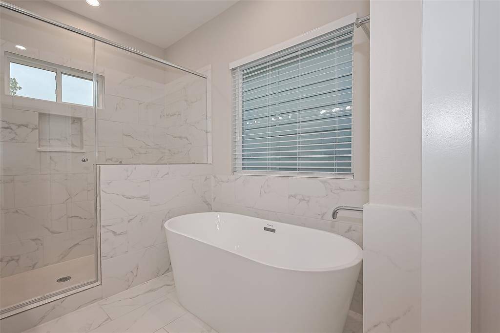 Primary bathroom with lovely soaking tub and separate stand up shower!