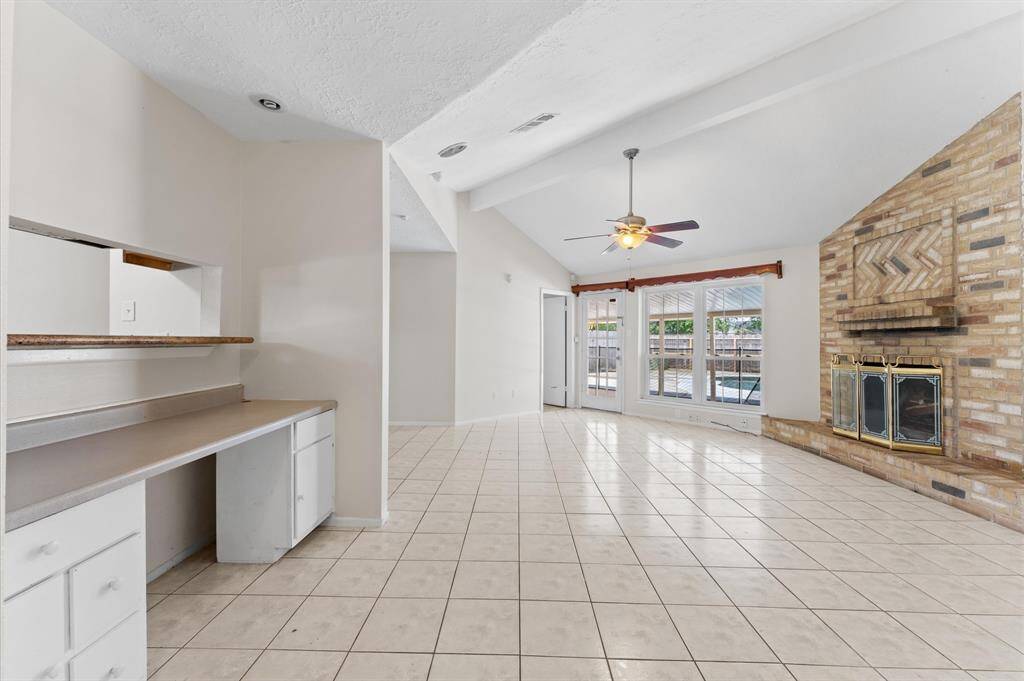 Bright and spacious living room with a dedicated office nook, perfect for work and relaxation.
