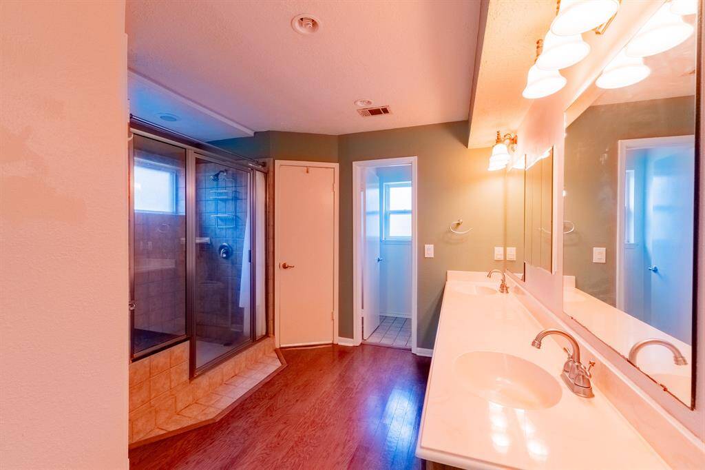Primary bath with large walk-in shower.  2 closets and separate toilet room. Huge double vanity.