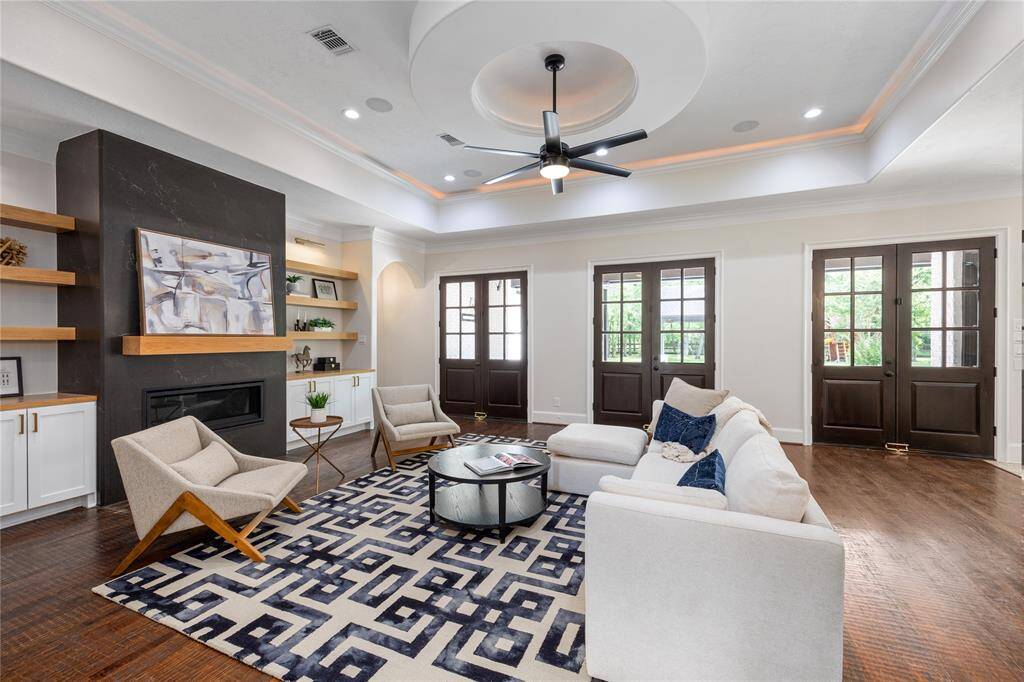 Enter into the elegant, yet warm living room. Custom built shelving and Cambria Slab Fireplace.