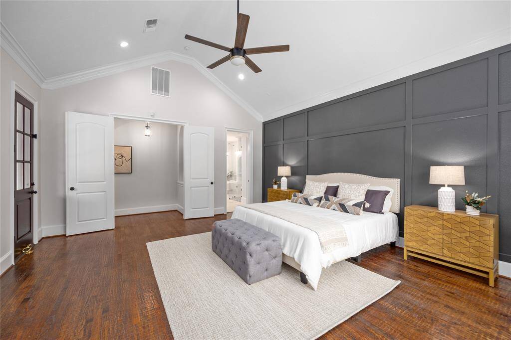 Custom accent wall is eye catching and helps elevate the look of this room! View also shows off the double door entry as well as a door that leads to the outdoor covered patio.
