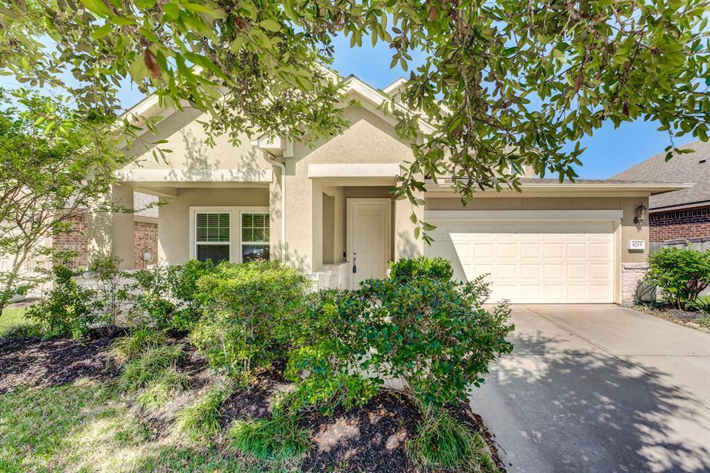 Mature landscaping provides front yard shade. Exterior is stucco and stone.