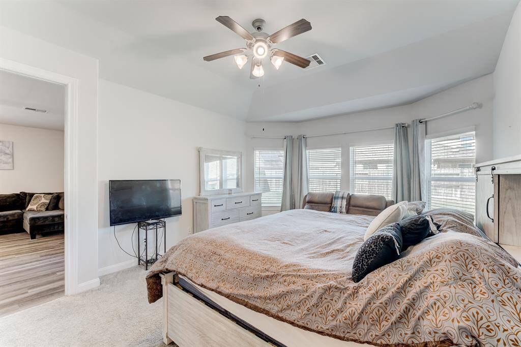 Primary bedroom offers a bay window providing a sitting area and a view of the back yard.