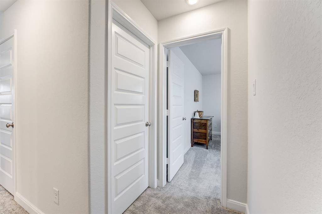 Opening to bedroom 3. the door to the left is bedroom 4.  The seller is packing right now and it is being utilized as a storage area.  No furniture in there just boxes.