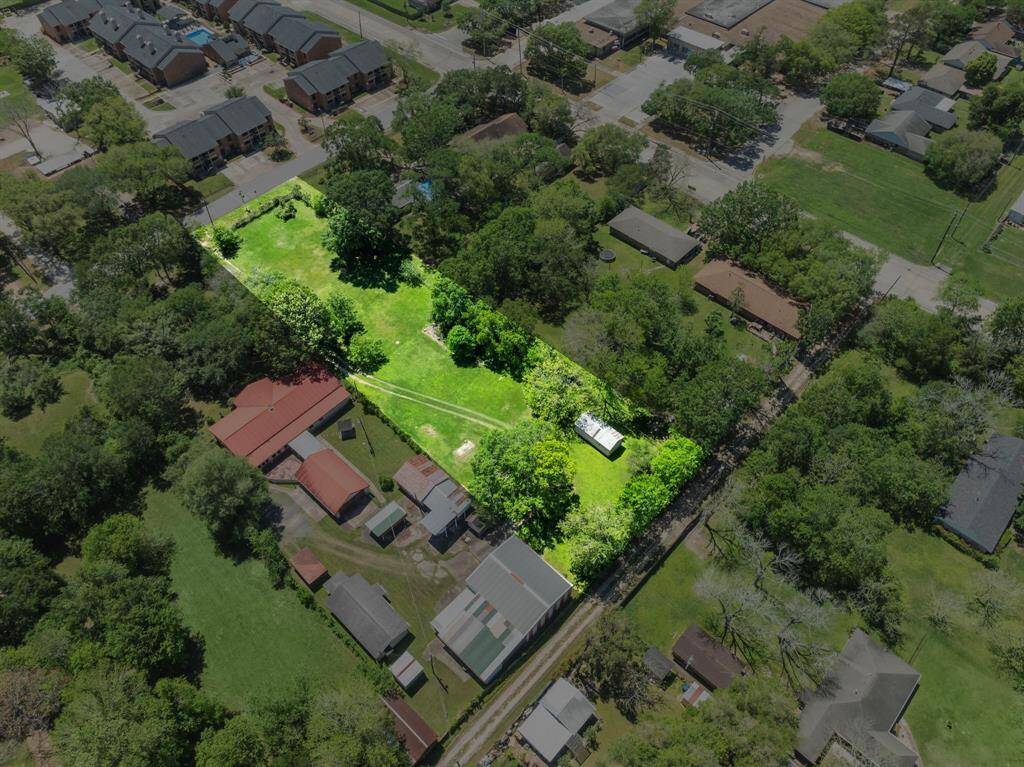 This angled view underscores the lot’s depth and central placement among established residences and newly built townhomes, reinforcing its development potential.