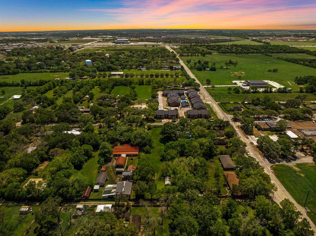 Sweeping sunset views showcase the full expanse of this tree-lined parcel, framed by nearby development and infrastructure—a compelling canvas for new construction.