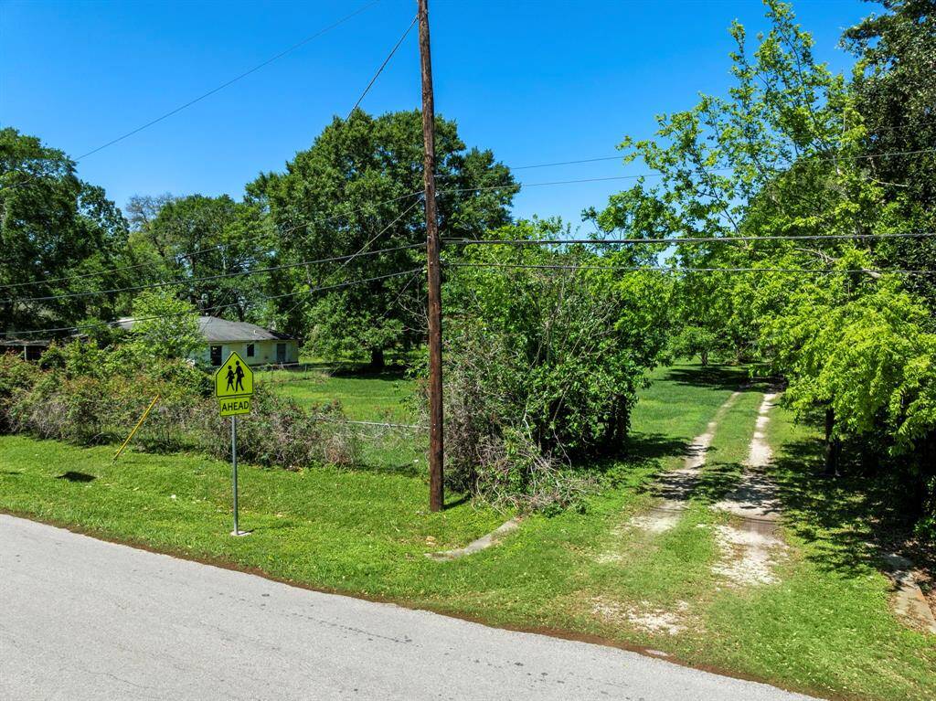 An open entrance with a visible path connects the lot to the street, offering direct access for future site development or construction activity.