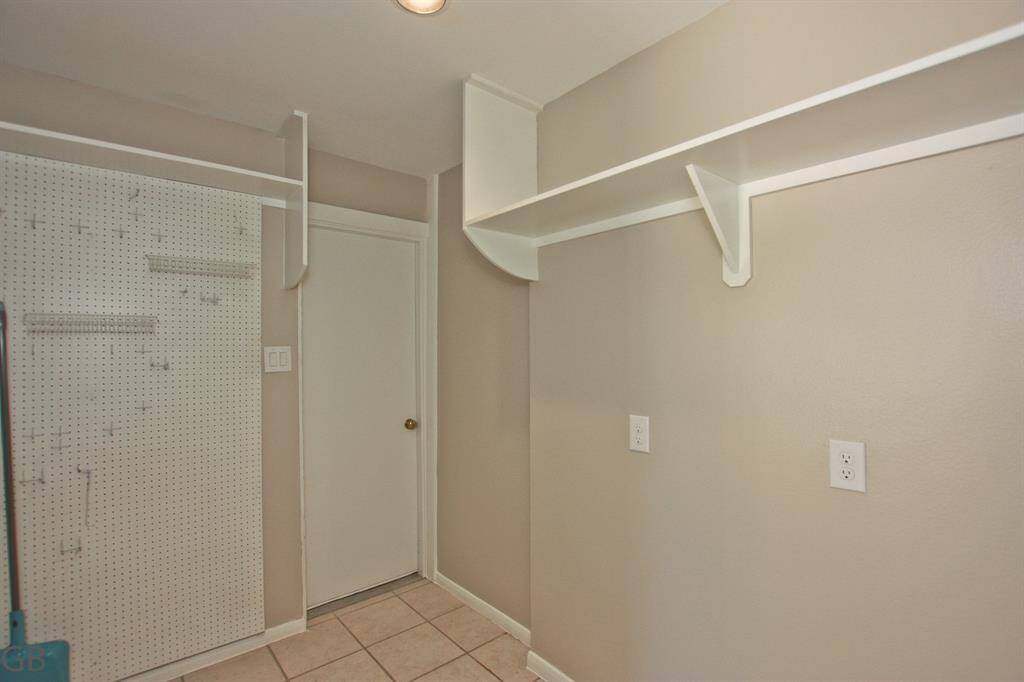 Additional climate-controlled storage off back hallway with garage access.