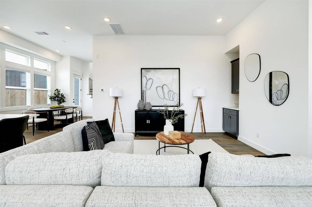 Step into modern comfort in this bright, airy living space, boasting elegant finishes and a seamless flow into the dining area for effortless entertaining.