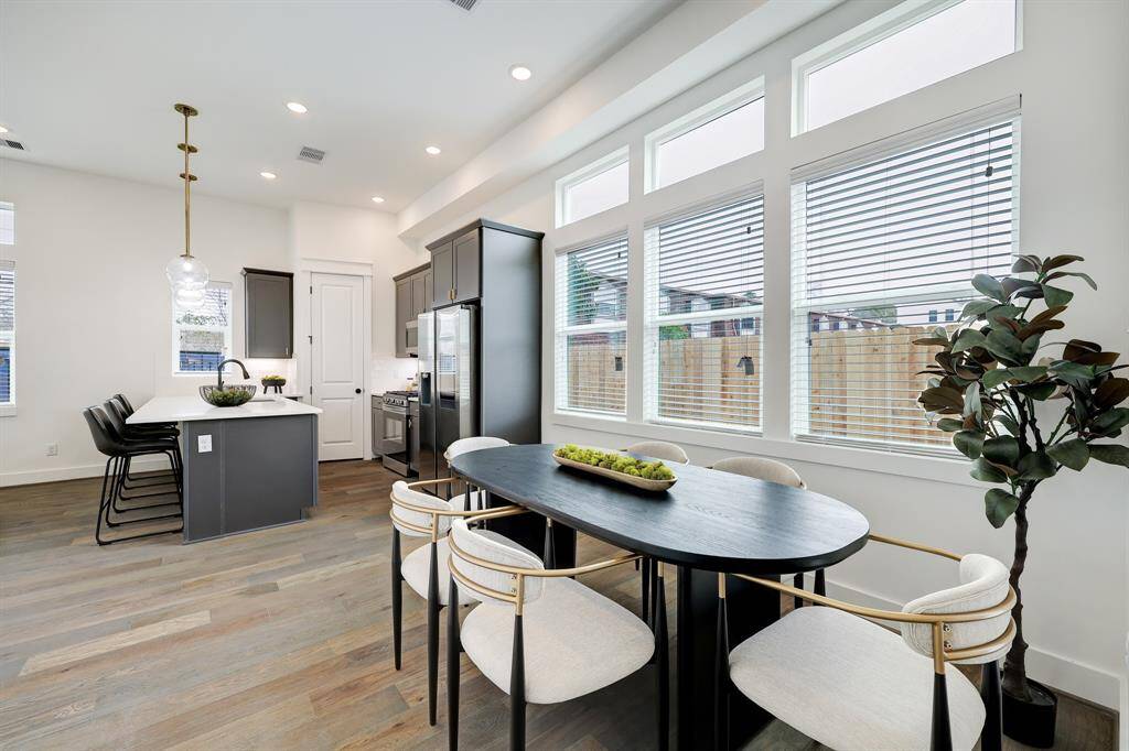 Modern Eat-In Kitchen: Features elegant cabinetry, sleek appliances, and a sunlit dining area perfect for both casual meals and intimate gatherings.