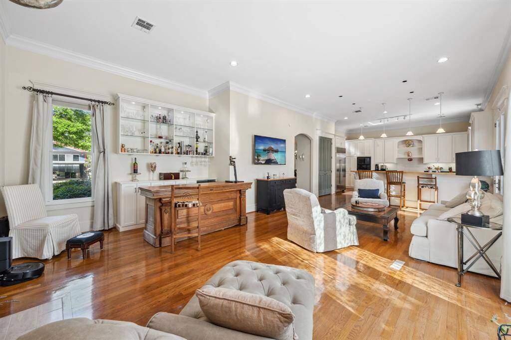 Spacious and bright family room featuring soaring ceilings and gleaming hardwood floors—perfect for relaxing or entertaining.