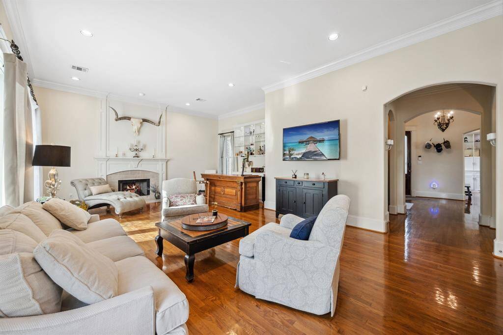 Cozy family room with a stunning stone fireplace, offering a seamless view from the kitchen.