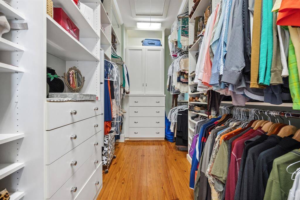Spacious walk-in closet in the primary bedroom features shelves and built-in storage.