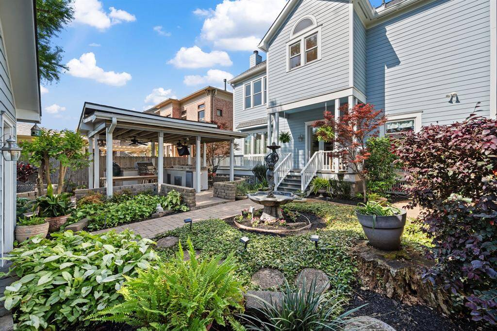 The backyard offers a tranquil retreat in the heart of the city, where you can relax to the soothing sounds of the fountain or entertain guests with the covered outdoor kitchen.