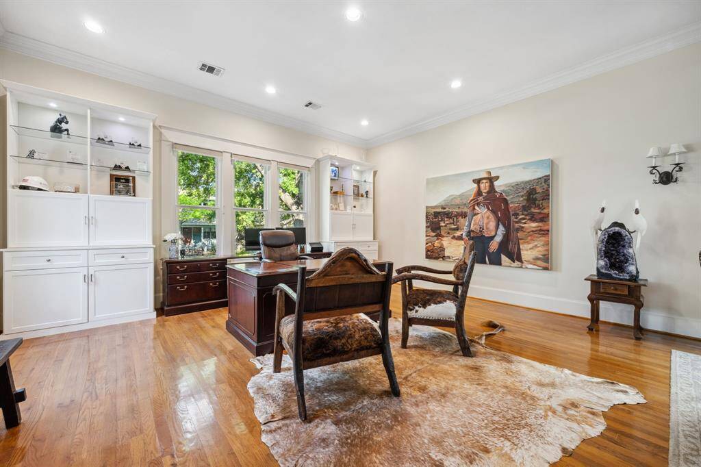 Another view of the formal living room, featuring abundant natural light from multiple windows.