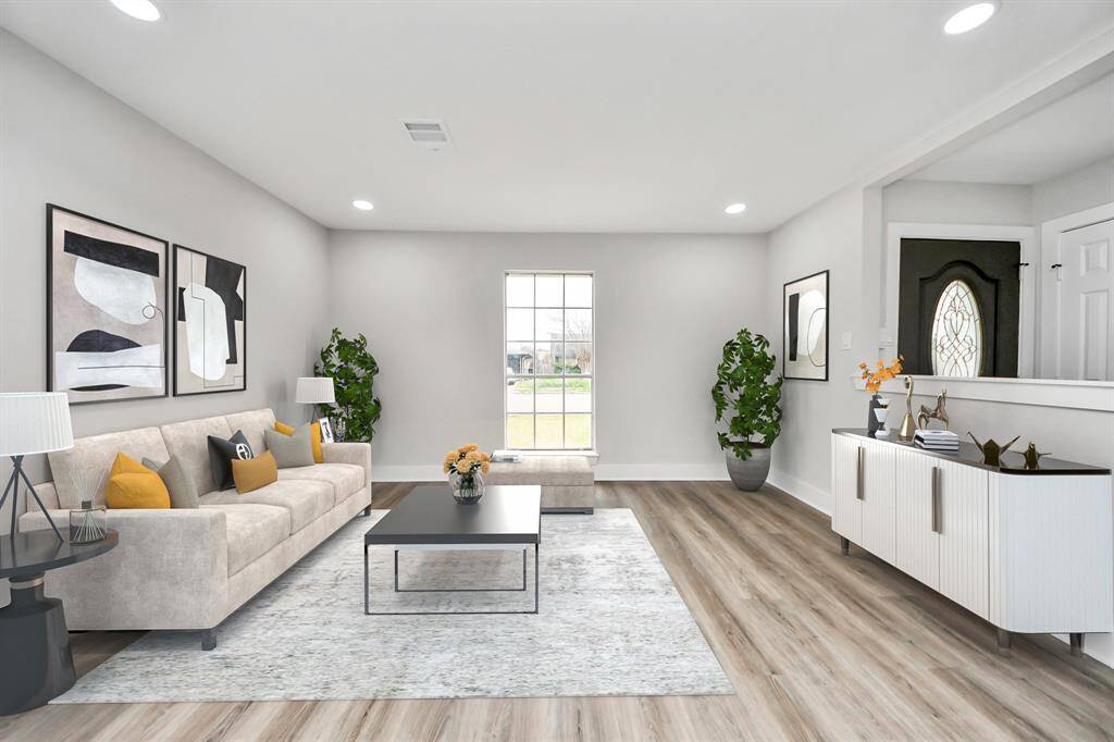 Step inside to find your living space on the right and your kitchen with a spacious breakfast area on the left. New LVP flooring throughout the entire home. This space has been virtually staged.