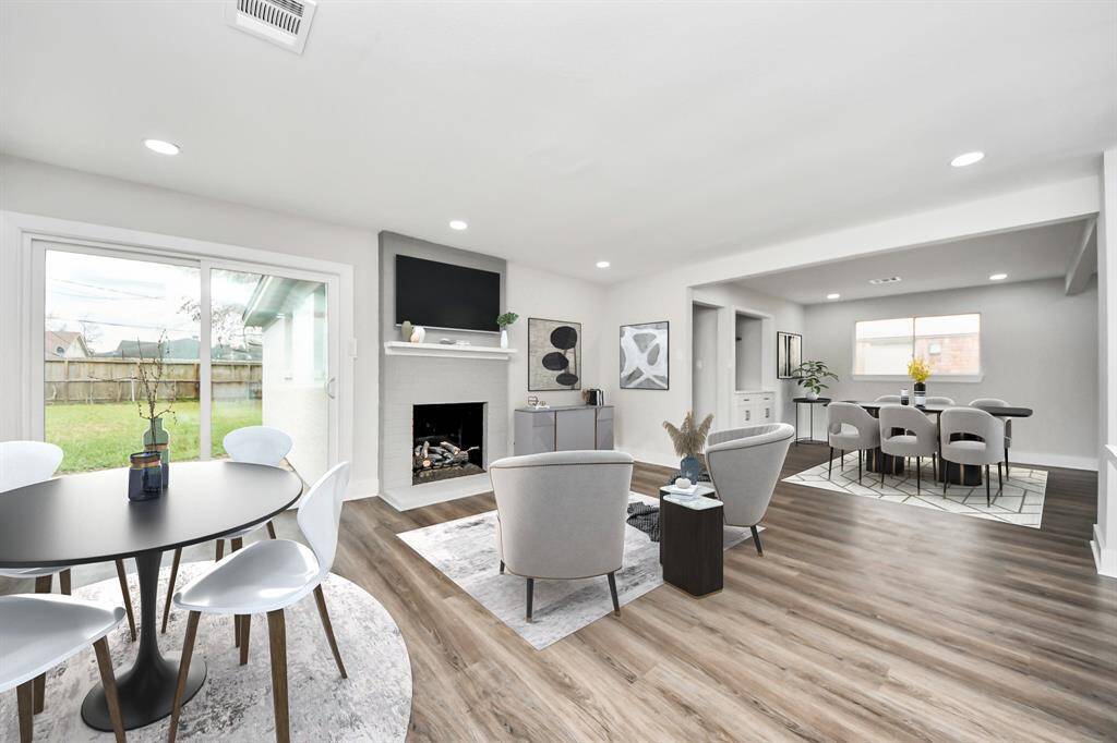 Enjoy a newly renovated fireplace and brand-new sliding doors that seamlessly connect your indoor and outdoor entertainment spaces. This space has been virtually staged.