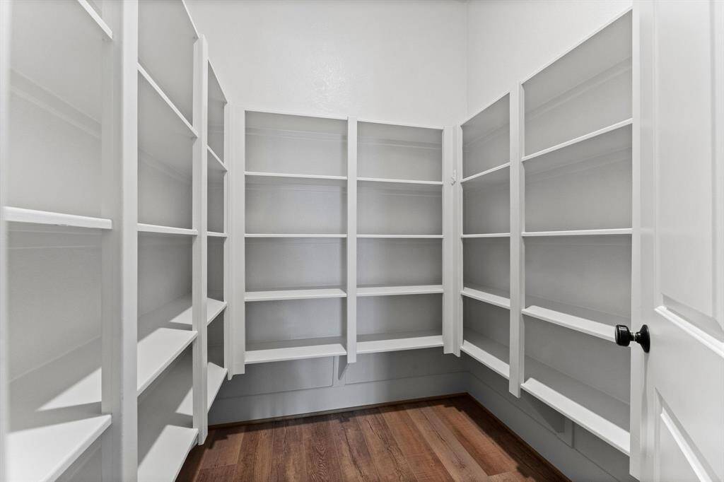 The expansive walk-in pantry, complete with extensive shelving, ensures effortless organization and convenience. A kitchen of this caliber is truly the heart of the home, where luxury meets everyday practicality.