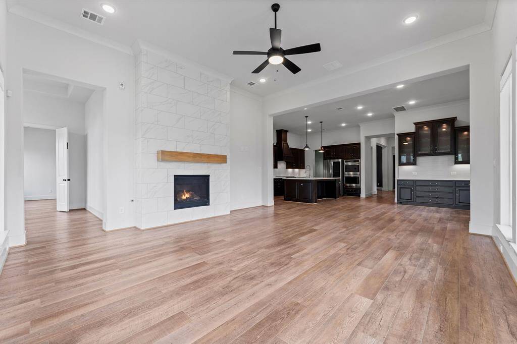 Great view of this home’s elegance looking toward the kitchen and breakfast room.  You will love this open concept floorplan that makes family living easy and is a dream for entertaining.
