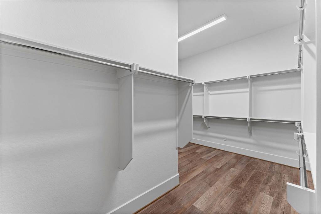 The HUGE walk-in closet is a suite unto itself with ample hanging space on all sides.