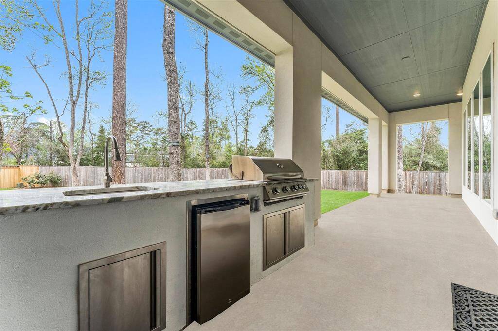 Take your cooking outdoors with this incredible outdoor kitchen, fully equipped with a built-in grill, beverage refrigerator, and sink—everything you need to host the ultimate outdoor gathering!