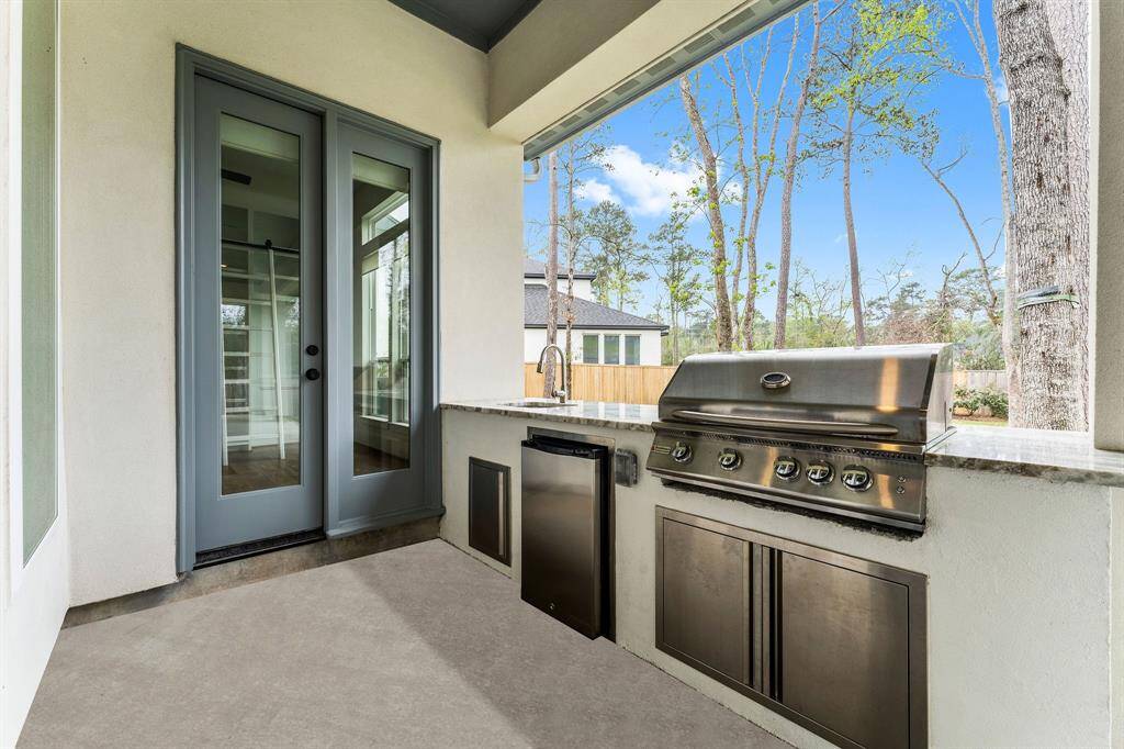 This space is perfect for lounging and enjoying the sights and sounds of nature while waiting for the grill to heat up or relaxing with a cold drink in hand. As the sun sets, you can take in the breathtaking views, making this outdoor area the ideal spot for unforgettable evenings with family and friends.