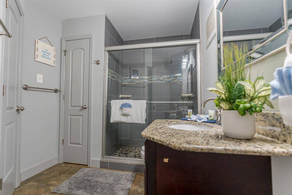 Bathroom with large shower with glass doors.