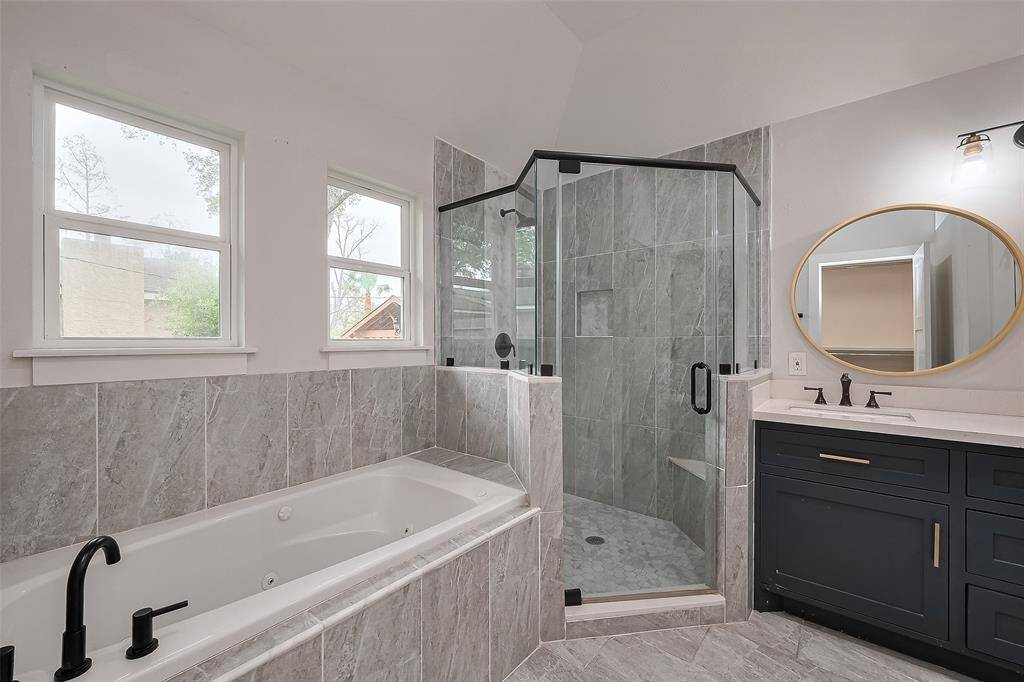 Primary bathroom featuring a soaking tub and a walk-in shower for ultimate relaxation.
