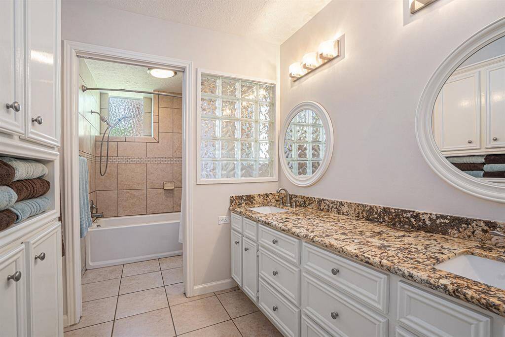 En Suite primary bath with double sinks, lots of cabinetry