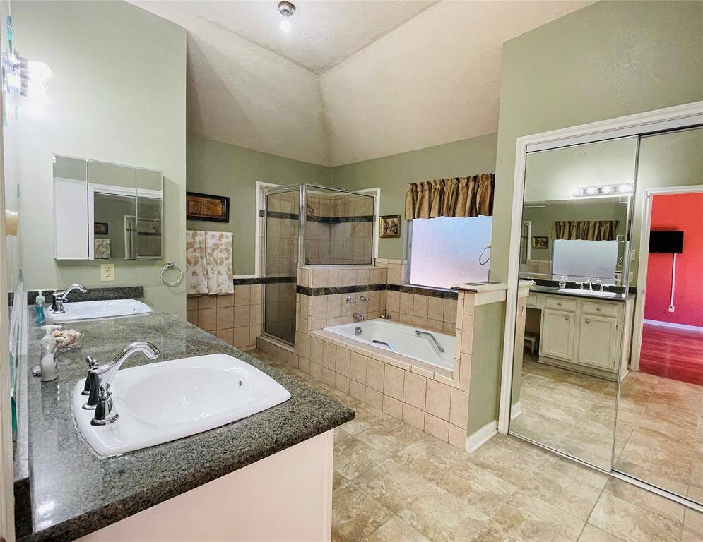 Primary bathroom has separate shower and tub. After a long and challenging day, enjoy relaxing in a soaking tub.